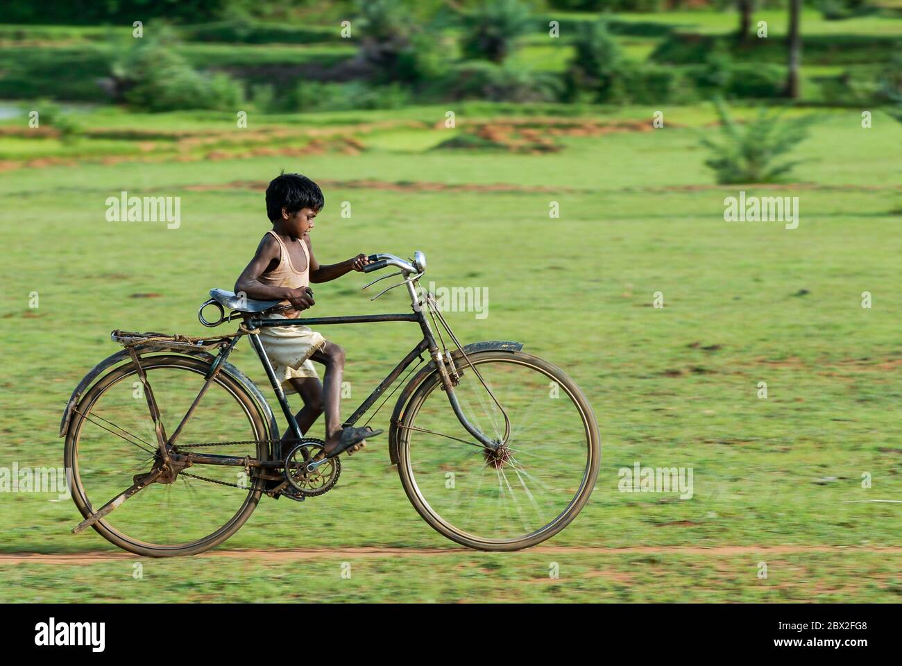 india-jharkhand-village-sarwan-adivasi-children-tribe-santhal-boy-on-large-bicycle-indien-jhar...jpg